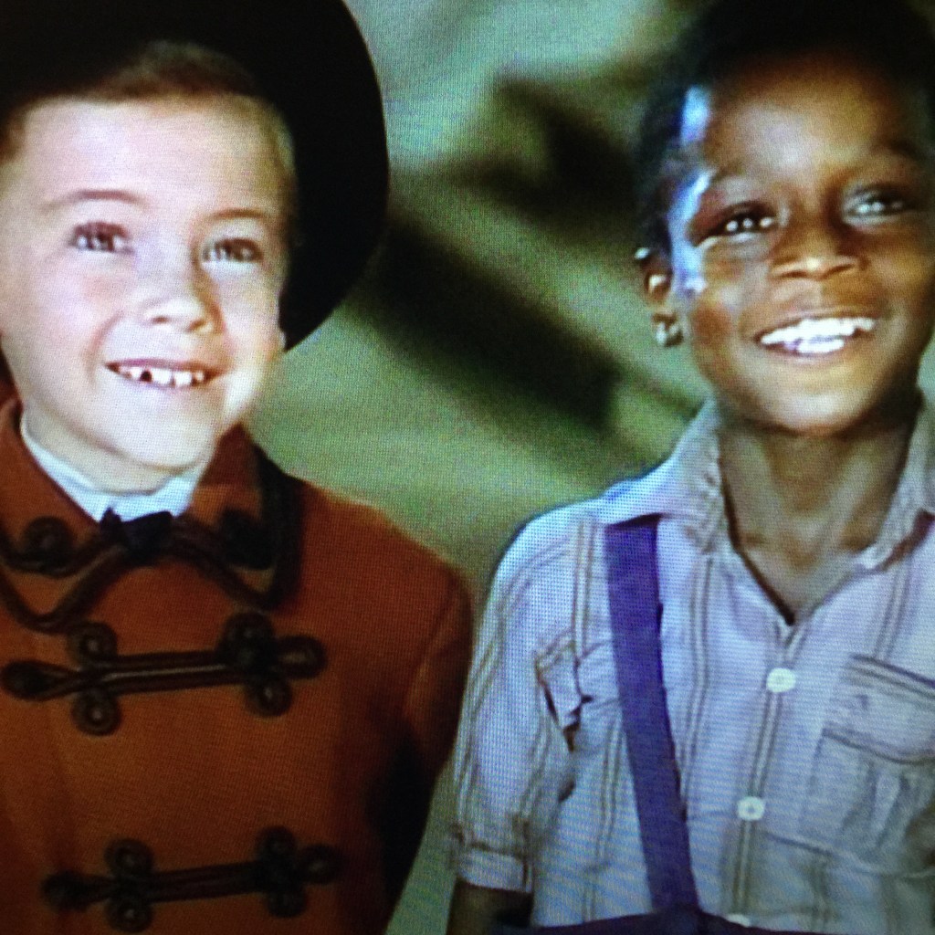 They look so innocent, considering they are hiding a frog behind their backs.